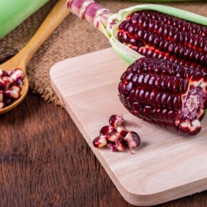 Fresh corn on cobs on rustic wooden table, closeup